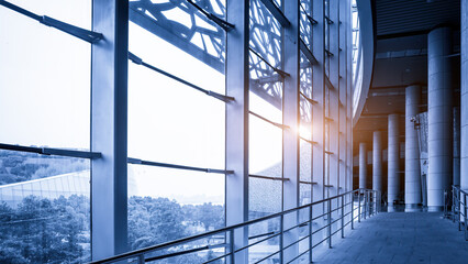 Modern office building corridor with large glass windows