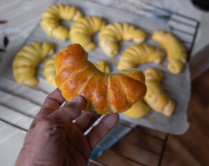 Freshly baked pastry varieties cooling on a rack in a domestic kitchen after just coming out of the oven