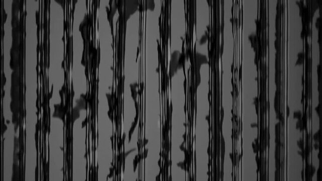 Vertical black streaks on a gray background