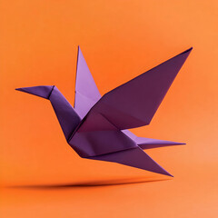 Purple origami paper bird against an orange background  © istudio