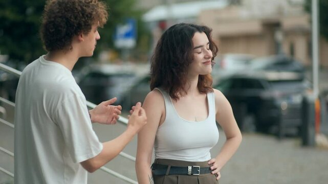 Young couple argues on the street as emotions run high and love breaks down