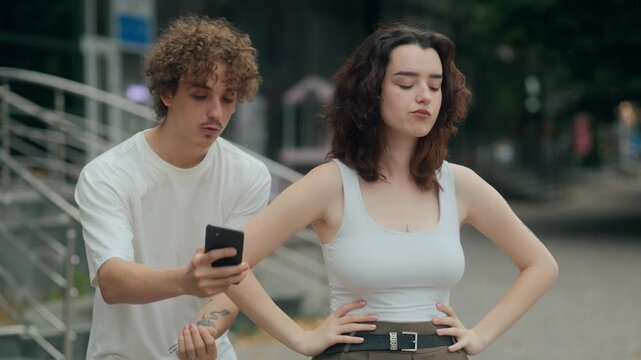 Young woman stays silent, ignoring partner is apology in street conflict