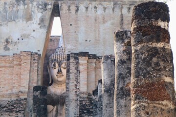 Majestic close-up of the ancient Buddha statue at Wat Si Chum, Sukhothai, Thailand. The serene face...