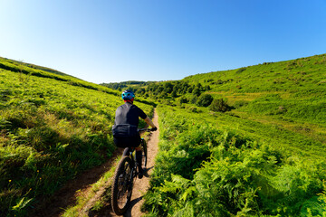 Fototapeta premium Cyclist on the Gr21 hiking path in the Antifer valley. Normandy coast