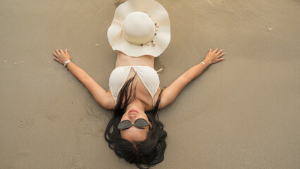 Young woman young woman relaxing on beach. Summer vacation concept.