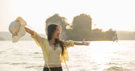 Portrait of beautiful woman enjoy on the beach at sunset