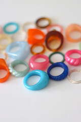 Collection of colorful plastic rings on white background. Selective focus.