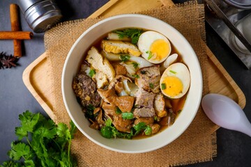 Chinese rolled noodles with crispy pork and egg in black soup,Rolled Rice Noodles in Five-spices Broth , Chinese noodles, thai called kuay jap
