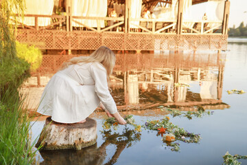On Ivan Kupala, a girl makes a wish and throws a wreath into the river. Celebration of Ivan Kupala in Donbass July 2025