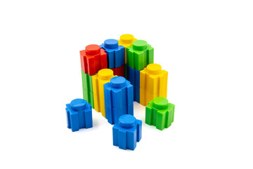 Colorful stacked plastic building blocks on white background