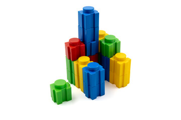 Colorful stacked plastic building blocks on white background