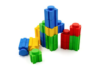 Colorful stacked plastic building blocks on white background