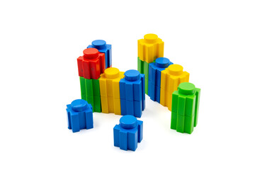 Colorful stacked plastic building blocks on white background