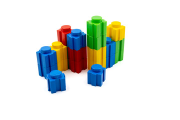 Colorful stacked plastic building blocks on white background