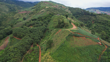 Aerial view from drone of rural village and mountain road