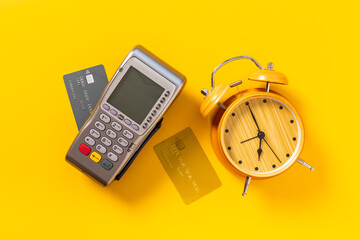 Pos payment terminal with bank card and alarm clock. Transaction speed. Time to pay concept