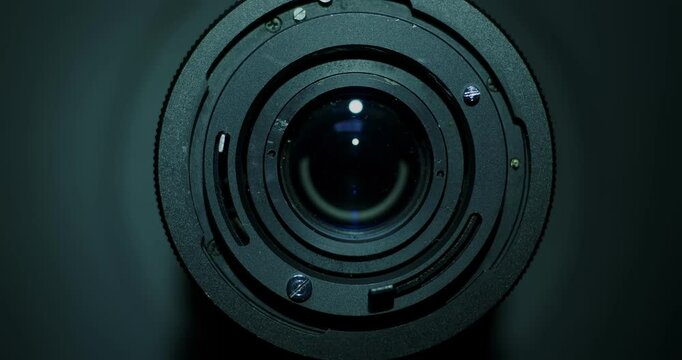 Vintage camera lens on turntable with light sweep and slow zoom