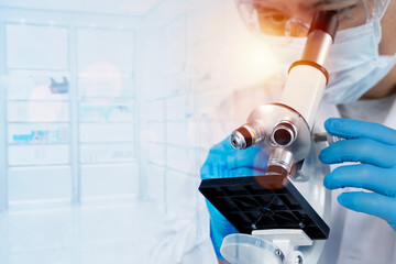 Scientist using microscope in bright modern laboratory, healthcare diagnostics and medical research...