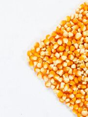 top view of isolated white background dry raw corn kernels with empty space for advertisment