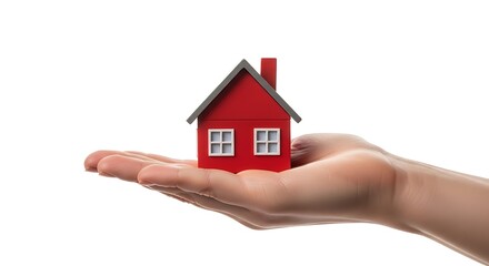 Red miniature house balanced on an open palm against a white background home real