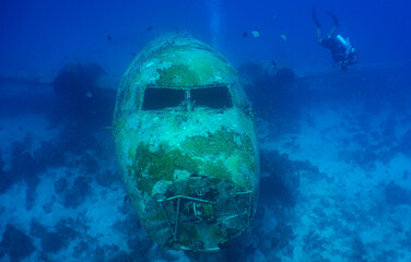 A diver exploring a sunken plane off the island of Aruba