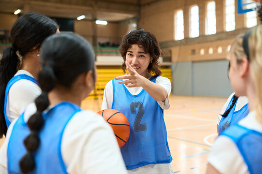 Female basketball player explaining game strategy to teammates