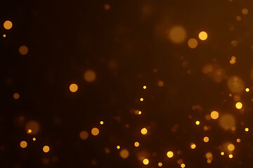 Abstract background with golden bokeh lights floating against a dark brown gradient with blurred circular shapes
