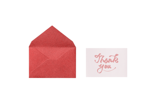 Overhead view of a cutout of a red lamé envelope with a pink handwritten thank-you card placed next to it