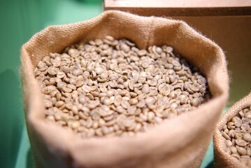 In selective focus of plenty roasted coffee beans in a sack bag