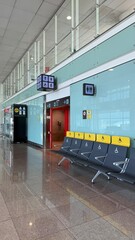 Barcelona, Spain - March 31, 2025: Airport terminal interior with modern seating, accessible...