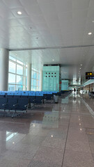 Barcelona, Spain - March 31, 2025: Modern airport terminal interior with spacious seating area and large windows providing natural light