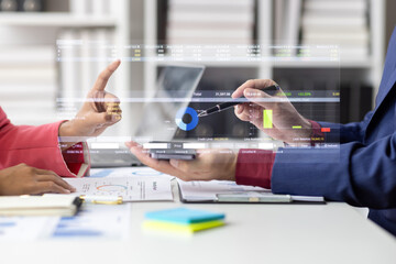 Business professionals are collaborating analyzing financial charts and data from a smartphone...