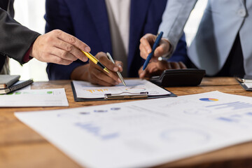 Business people working together, analyzing financial documents. Financial advisor and auditor are...