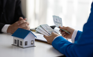 House and land trading ideas. Businessman, real estate agent counting money.