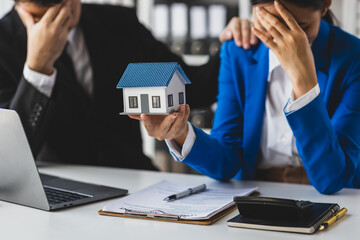Businesswoman is stressed because she owes her mortgage payment. Woman with financial problems.