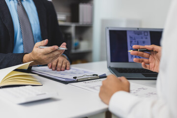 Employer interviewing job applicant and discussing resume details.