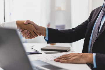 Job applicant submits resume documents, manager is interviewing new employee in office. Handshake...