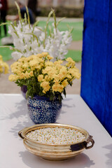 Floral arrangement with yellow chrysanthemums and a bowl of white daisies, adding color and...