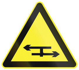 Warning road sign in China - T junction with a dual carriageway
