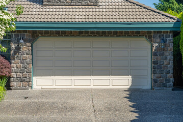 Garage door in luxury house with trees and nice landscape in Spring in Vancouver, Canada, North...