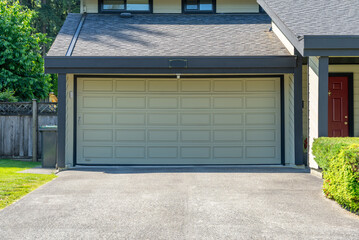 Garage door in luxury house with trees and nice landscape in Spring in Vancouver, Canada, North...