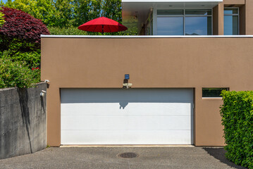 Garage door in luxury house with trees and nice landscape in Spring in Vancouver, Canada, North...