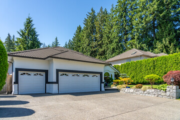 Garage door in luxury house with trees and nice landscape in Spring in Vancouver, Canada, North...