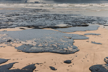 Oil spill contaminates sea beach shoreline