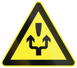 Warning road sign in China - Pass obstacle on either side