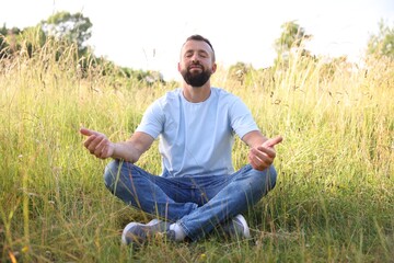 Feeling freedom. Happy man enjoying time outdoors