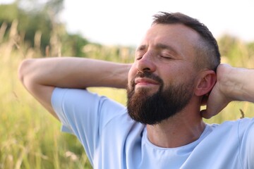 Fototapeta premium Feeling freedom. Happy man enjoying time outdoors