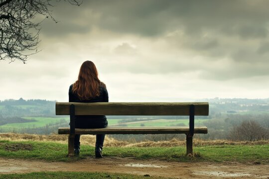 Sad Woman Alone on Park Bench Outdoors