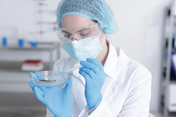 Scientist working with sample in Petri dish in laboratory