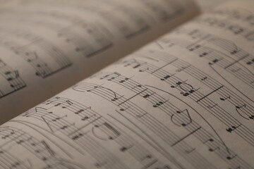 Sheets with musical notes as background, closeup